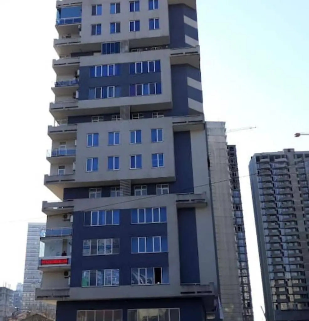 A large building with alternating blue and white colors.