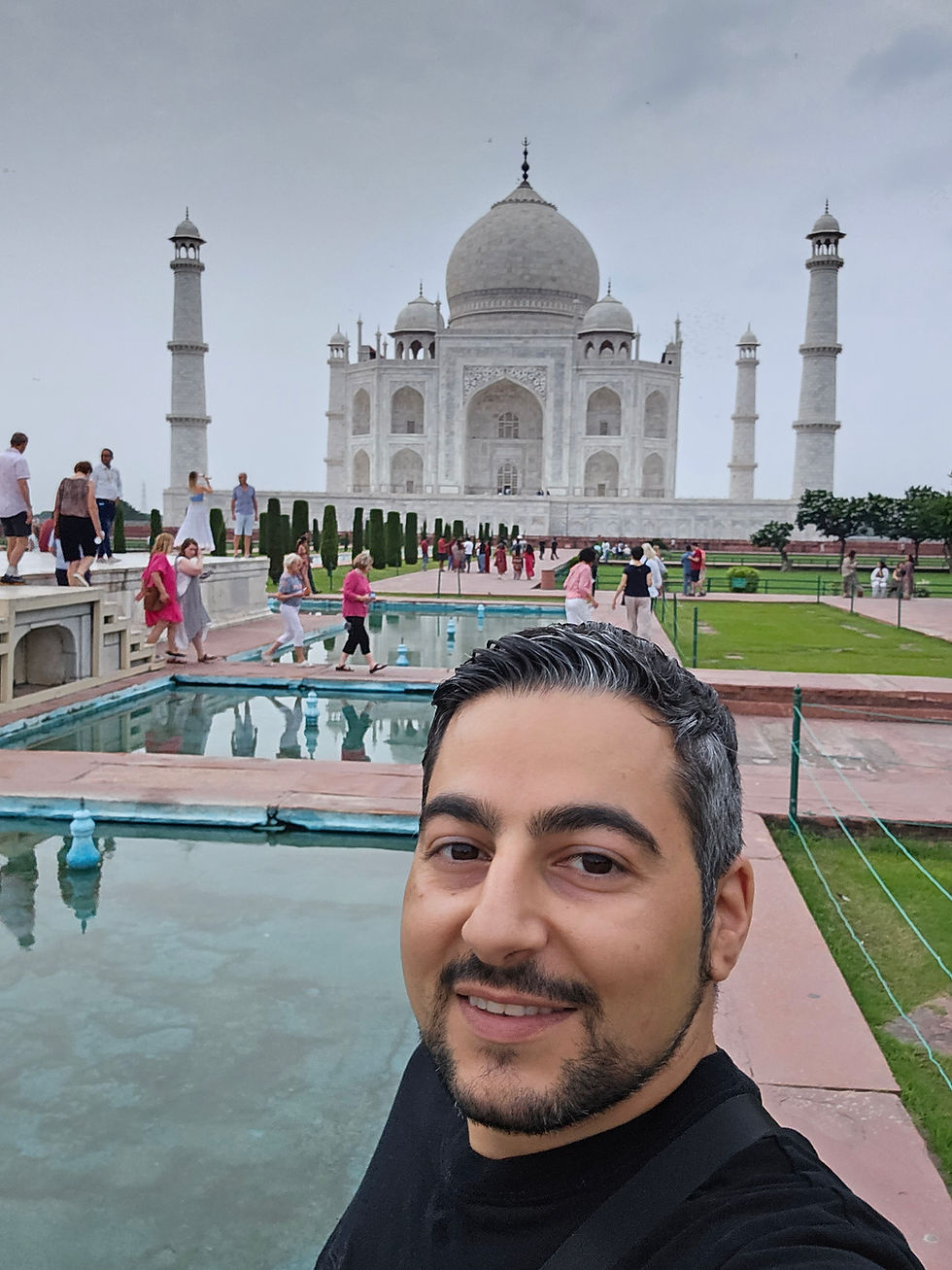 A man standing in front of the Taj Mahal, Agra, India
