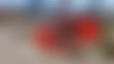 Historic Durrës Amphitheatre with modern buildings in the background. Bright day with a red and black splash displaying its name.