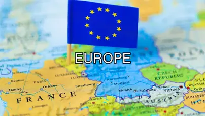 Magnifying glass focusing on a map of europe.