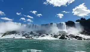 Niagara Falls cascading into the gorge on the Canada side, mist rising.