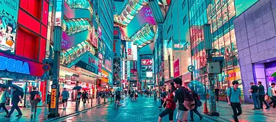 A bustling street in Akihabara filled with bright neon signs, futuristic architecture, and pedestrians under a blue glow.