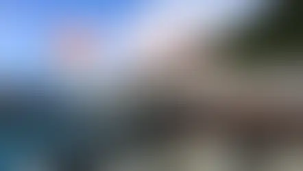 Person on glass walkway at Jasper Skywalk, surrounded by mountains and trees. Clear sky with "Jasper Skywalk" text overlay and Canadian flag.