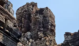 Stone face tower at Bayon Temple with carved smiling faces, Angkor Thom, Cambodia.