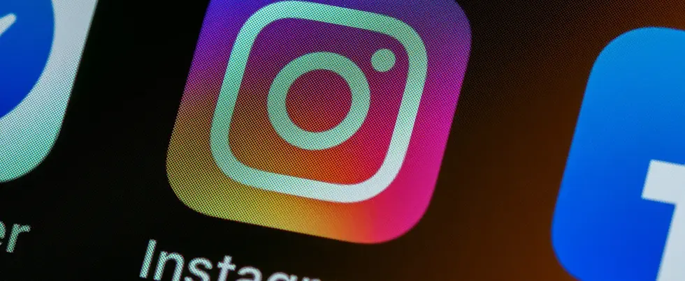 Instagram app icon on smartphone screen representing social media marketing, content creation, and Instagram growth.