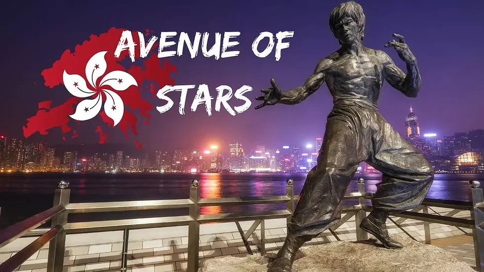 Statue of a martial artist in a fighting pose on the Avenue of Stars in Hong Kong, with city lights in the background and the words "Avenue of Stars" in white text.
