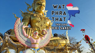 Golden statue of a deity at Wat Phra That in Doi Saket, with a bird-like figure in front. Text reads "Wat Phra That Doi Saket" alongside Thai national colors map. Clear blue sky in background.