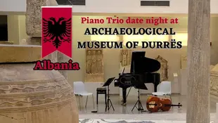 Piano and cello set for a trio at Archaeological Museum of Durrës, Albania. Historic sculptures in the background, text overlaid.