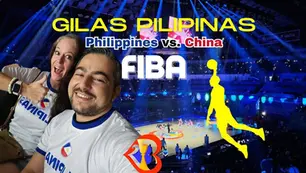 Smiling fans in "Pilipinas" shirts at a basketball game. Text: "GILAS PILIPINAS, Philippines vs. China, FIBA." Vibrant arena lights.