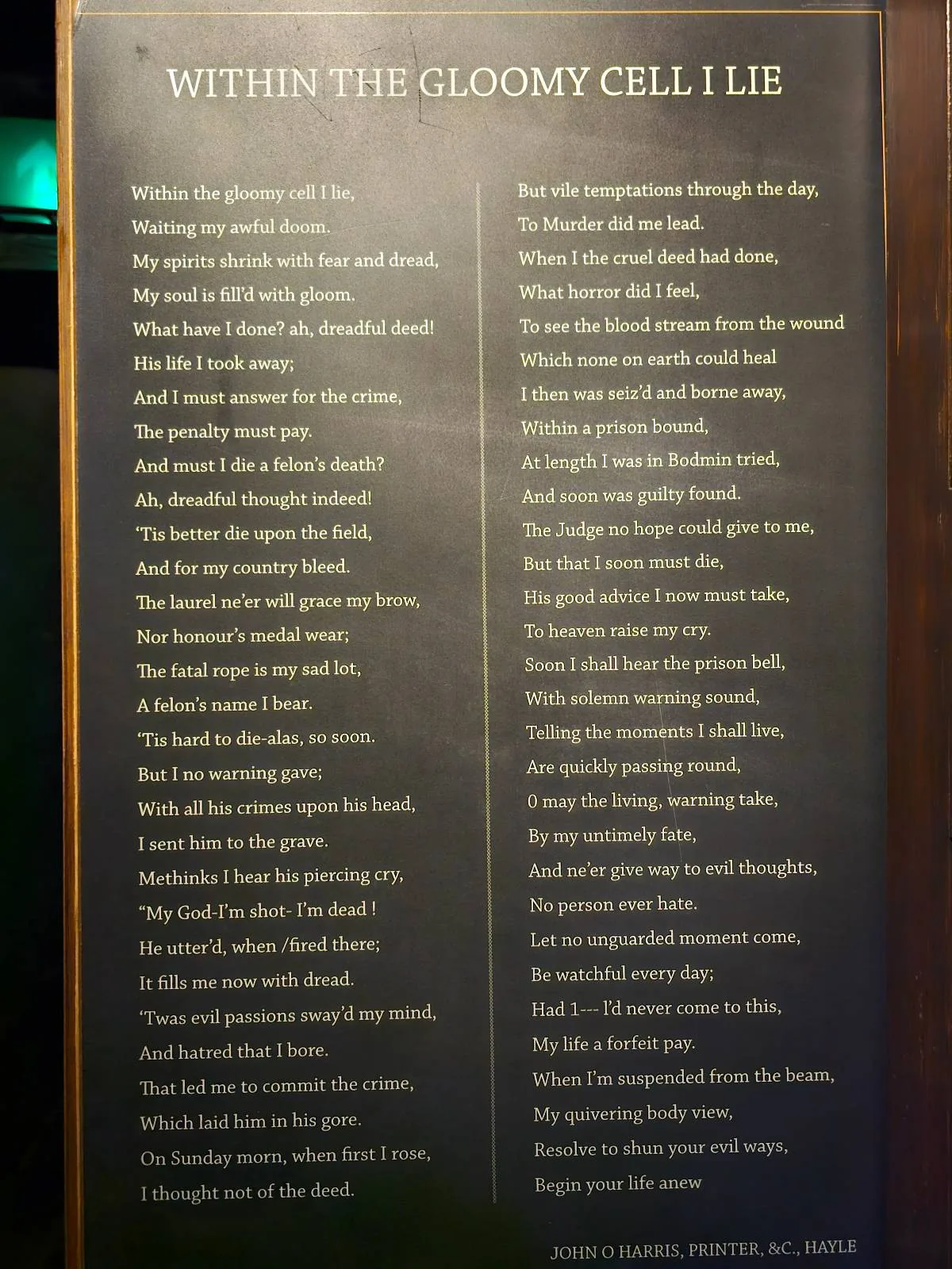 A close-up of a page from a book displaying a poem, written in clear, legible text on a slightly illuminated surface.