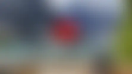 Woman sits by Moraine Lake, turquoise water, driftwood, rocky mountains in background. Text: Moraine Lake, Banff National Park.