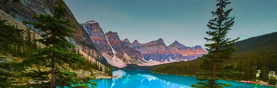 Stunning view of Moraine Lake and snow-capped peaks in Banff National Park, Alberta, highlighting a Canadian road trip adventure.