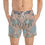 Thumbnail: A person wearing Crystal Rock Swim Trunks with a stone and sand pattern design, part of the Mexican Tile Style Collection.