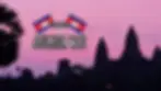 Silhouettes of Angkor Wat temples against a pink sunset sky, with the Cambodian flag and "Angkor Wat" text overlay.