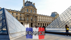 The Louvre Museum in Paris with its glass pyramids, a woman taking a photo, and "FRANCE" written over a painted French flag in the center.