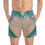 Thumbnail: A person wearing swim trunks featuring a teal and cream marble pattern stands with hands in pockets, ready to hit the waves.