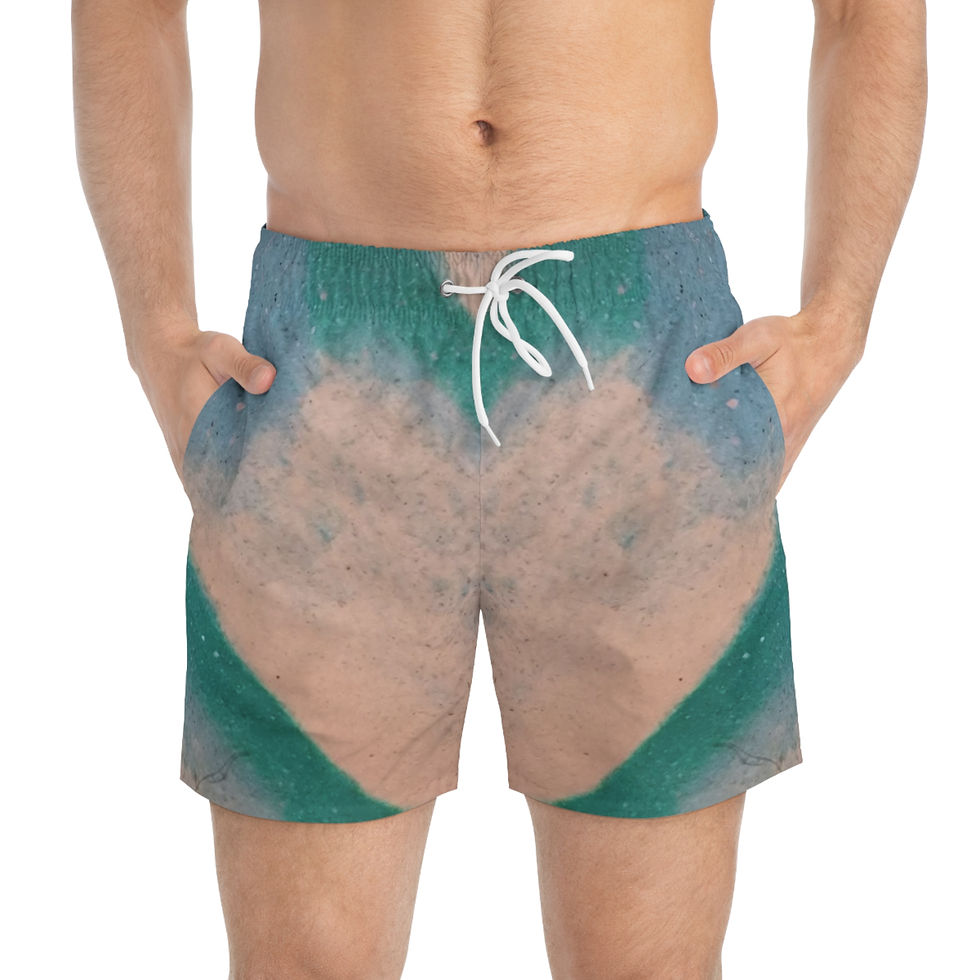 A person wearing swim trunks featuring a teal and cream marble pattern stands with hands in pockets, ready to hit the waves.