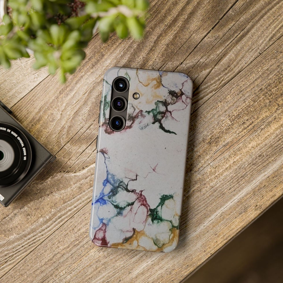 A smartphone with a colorful, abstract floral case lies on a wooden surface next to a camera and a green potted plant.