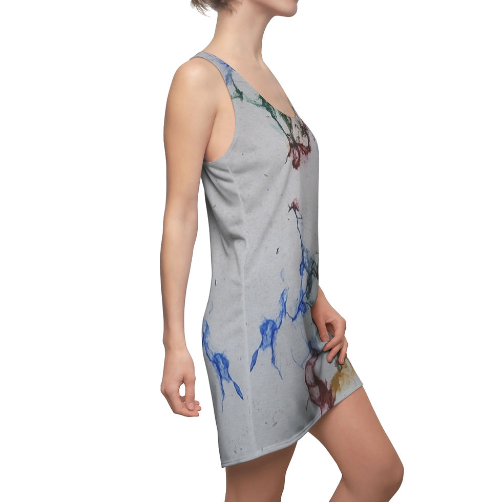 A person is standing sideways in a sleeveless racerback dress, featuring colorful abstract patterns.