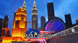 Cityscape featuring the Petronas Towers and surrounding buildings at dusk in Malaysia, with the country's flag and "Malaysia" text overlaid in the forefront. Ideal for a travel blog offering budget travel tips to explore this stunning destination without breaking the bank.