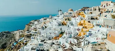 Whitewashed cliffside buildings overlooking the sea in Santorini, Greece.