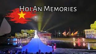 Nighttime performance at Hoi An Memories, with a large illuminated figure, colorful lights, and traditional ships against a city backdrop. Vietnam flag graphic with text at the top.