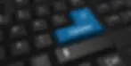 Close-up of a computer keyboard with a prominent blue "update" button replacing the usual "enter" key.