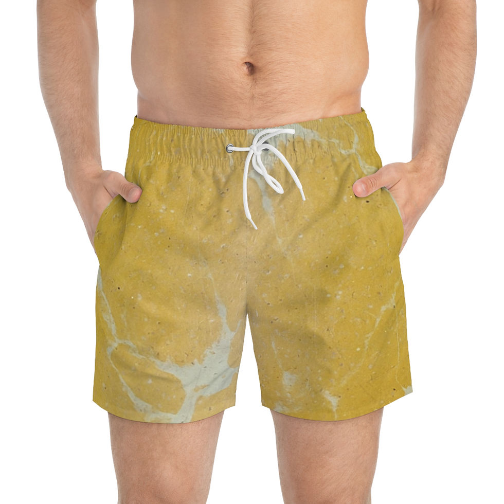 A person wearing mustard yellow swim shorts with a white drawstring and splatter pattern.