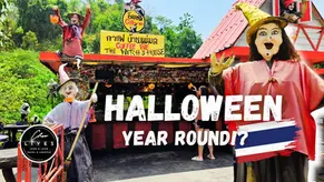 Witch statues in vibrant costumes outside "Coffee We" café. Halloween decor with a festive mood in a lush, green setting.