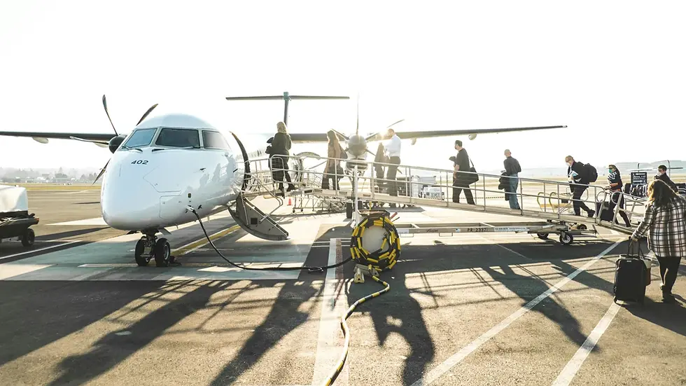 People boarding a small airplane via a ramp on a sunny runway. The plane is white with "402" visible. The mood is calm and busy.