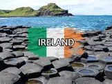 Hexagonal basalt columns of the Giant's Causeway along the rugged Irish coastline, overlaid with the Irish flag and bold text reading "IRELAND".