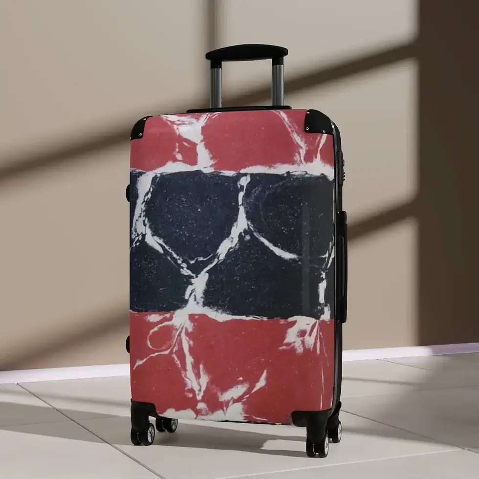 A stylish suitcase with a bold red and black marble pattern stands upright on a sunlit floor, casting a shadow.