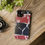 Thumbnail: A smartphone with a red, black, and white marble-patterned case rests on a wooden surface next to a camera.