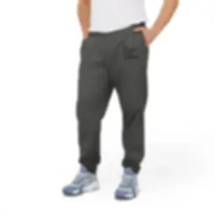 Model wearing Dark Grey Heather “The Proof is in the Pudding” Adidas fleece joggers.