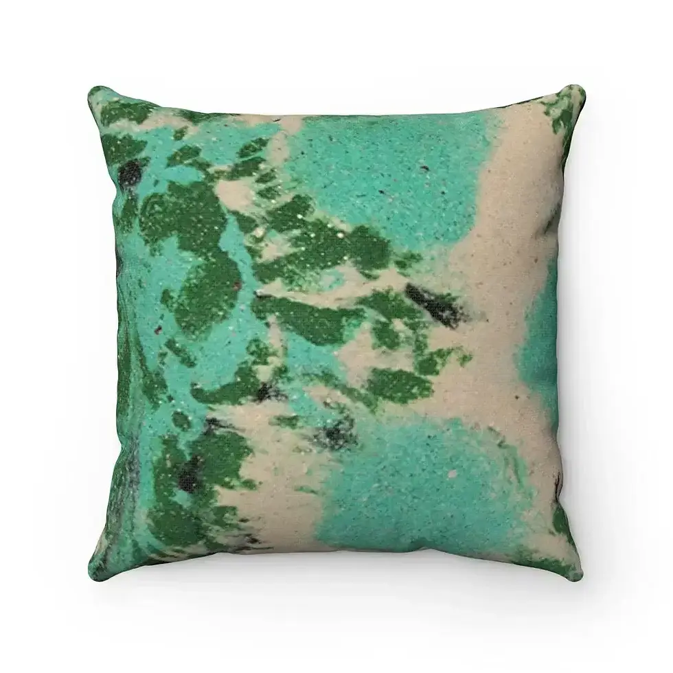 A square cushion featuring an abstract design with green and teal splashes on a beige background.