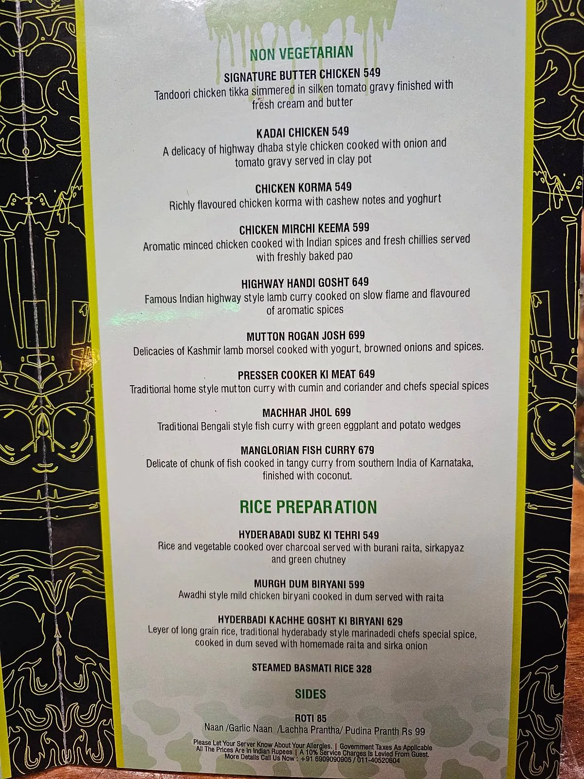 A hand holds a breakfast menu featuring a variety of food and drink options, including eggs, omelettes, pancakes, sandwiches, sides, juices, and hot beverages, with prices listed beside each item.