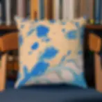 A decorative cushion with a blue and beige abstract pattern sits on a wooden chair, positioned in front of a bookshelf.