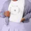 Thumbnail: A person wearing a white shirt with "BRIDE TO BE" printed in a circle around a small heart, paired with a light purple jacket