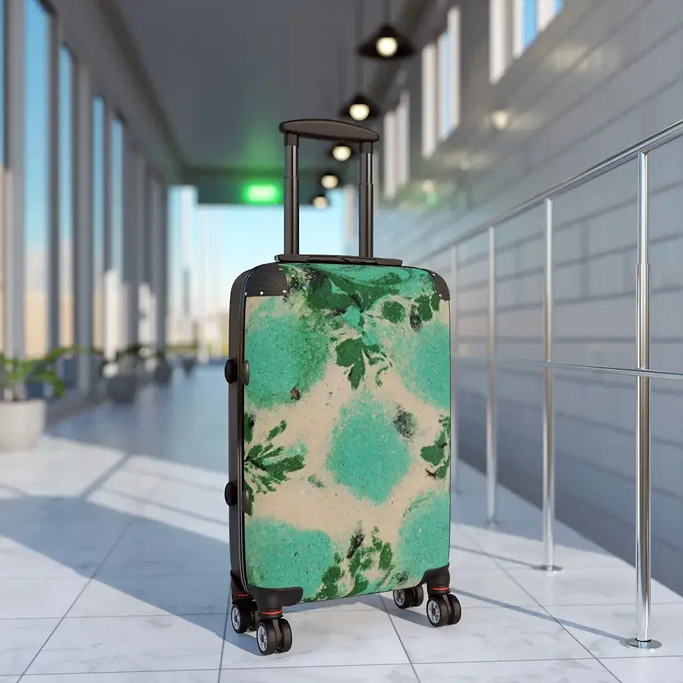 Rolling suitcase with green and white pattern in an airport or train station.