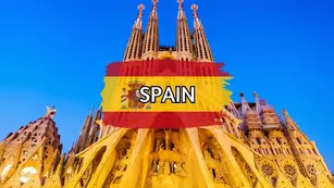 Basílica de la Sagrada Família in Barcelona, Spain under a blue sky with Spanish flag artwork and SPAIN text overlay.