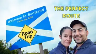 Couple taking a selfie beside a Welcome to Scotland road-trip sign, with THE PERFECT ROUTE text against a bright sky.