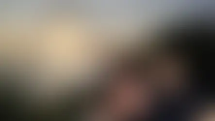 Couple smiling at Balian Beach during sunset. Text: "The Best Beach in Bali." Ocean and greenery provide a serene backdrop.