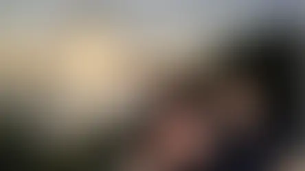 Couple smiling at Balian Beach during sunset. Text: "The Best Beach in Bali." Ocean and greenery provide a serene backdrop.