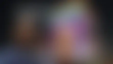 Two people smiling in front of a brightly lit India Gate at night. Text reads "Feeling like celebrities at India Gate."