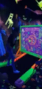 A person plays mini-golf in a neon-lit room with glowing spells board. Vibrant green, orange hues, and floating decor create a magical vibe.