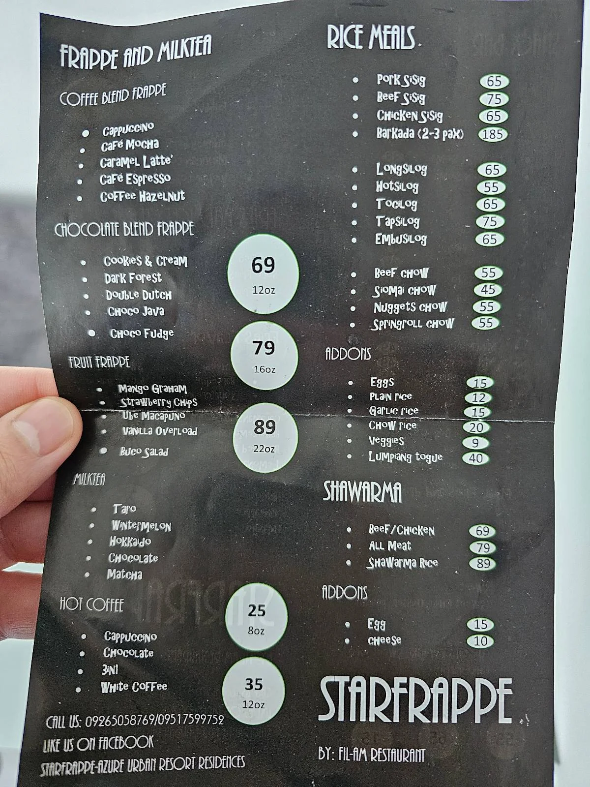 A hand holding a menu with various frappe, milk tea, and snack options. Prices are listed next to items in PHP currency. The menu is for "Starfrappe" and includes items like chocolate moist tower, rice meals, and frappes.