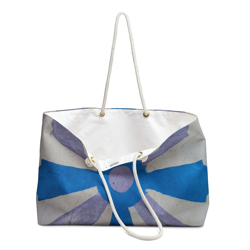 A canvas tote bag featuring a blue and white abstract design reminiscent of the Mexican Tile Style.