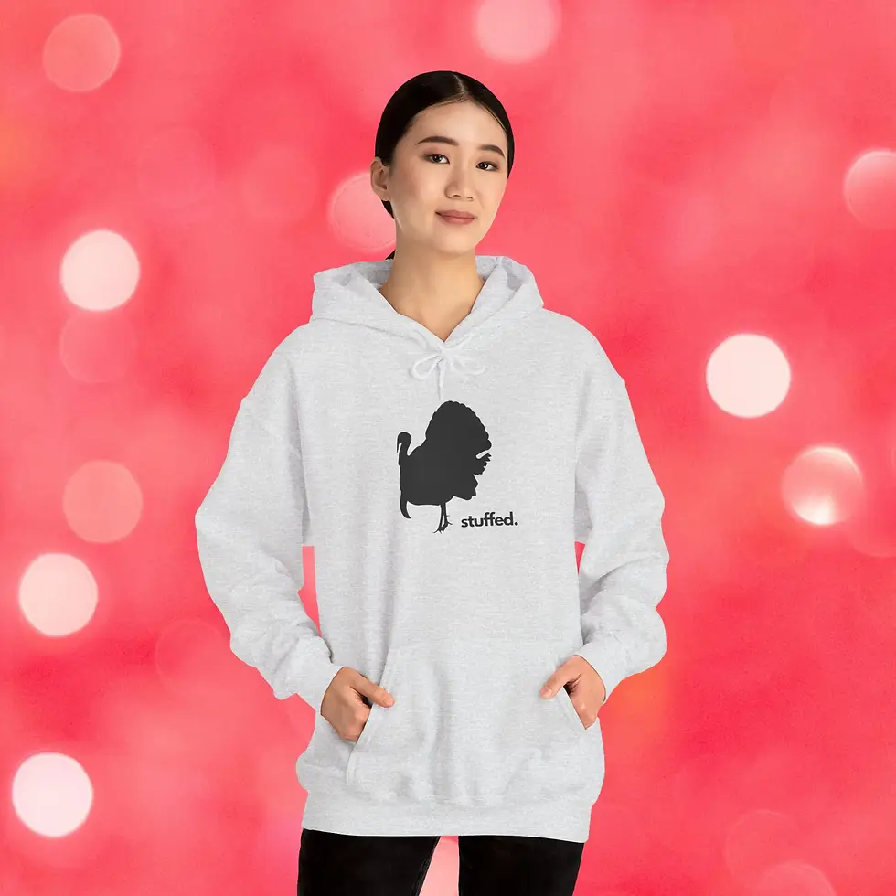 Woman wearing white hoodie with text and design, smiling at camera, background.