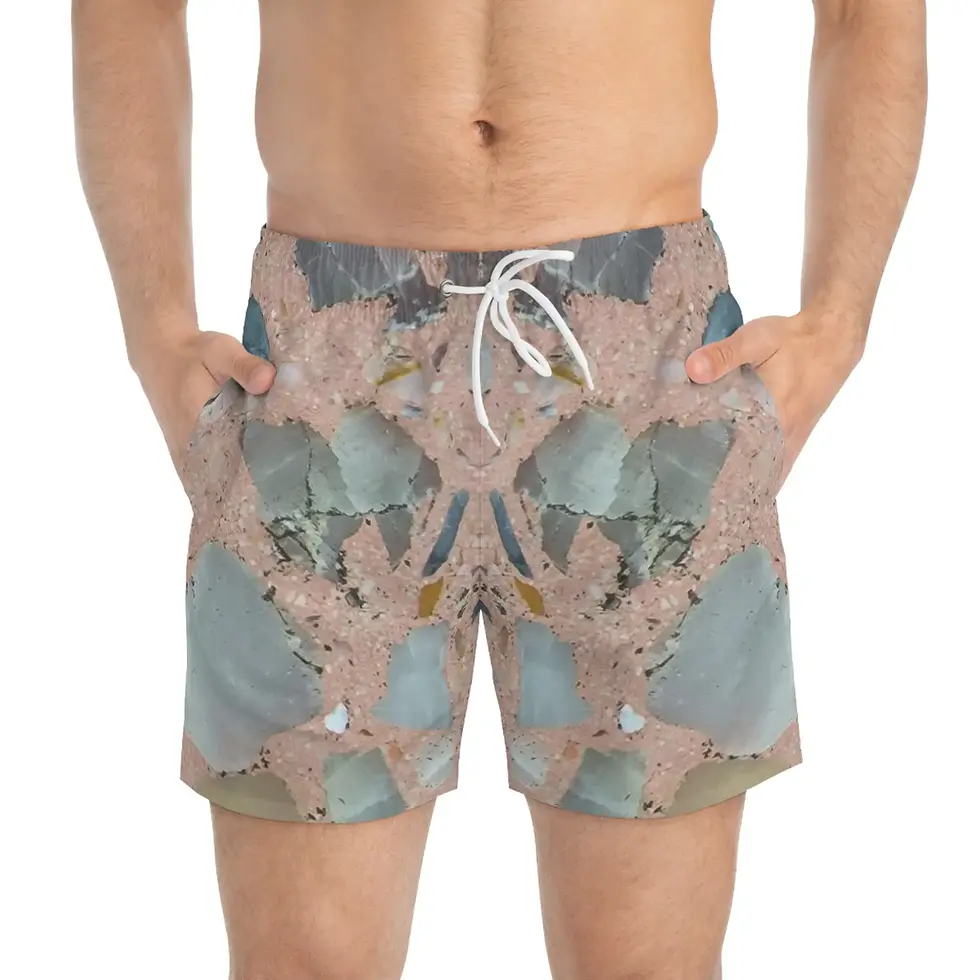 Man wearing Crystal Rock Swim Trunks | Mexican Tile Style shorts with hands in pockets.