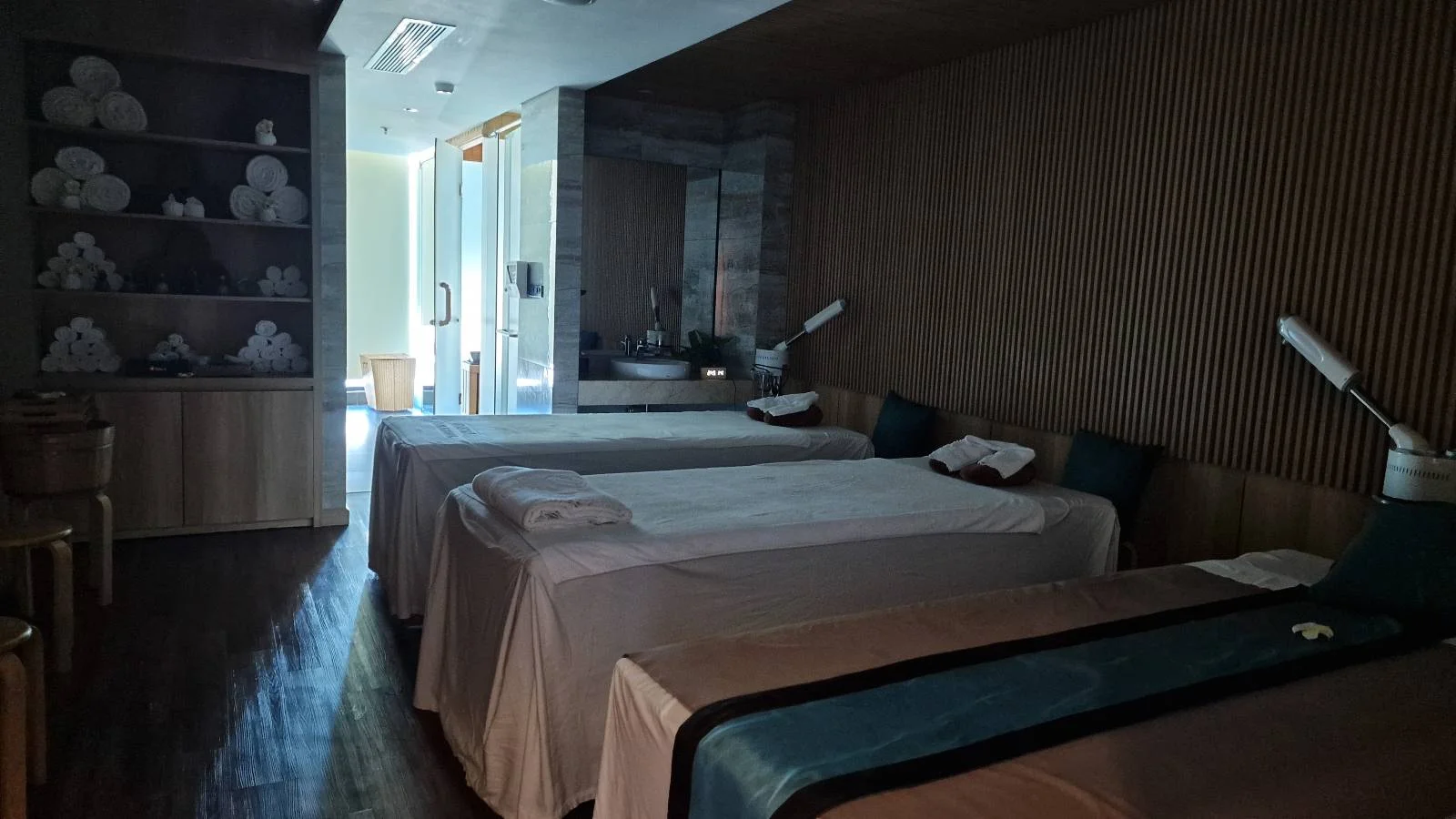 A room with beds and a mirror.